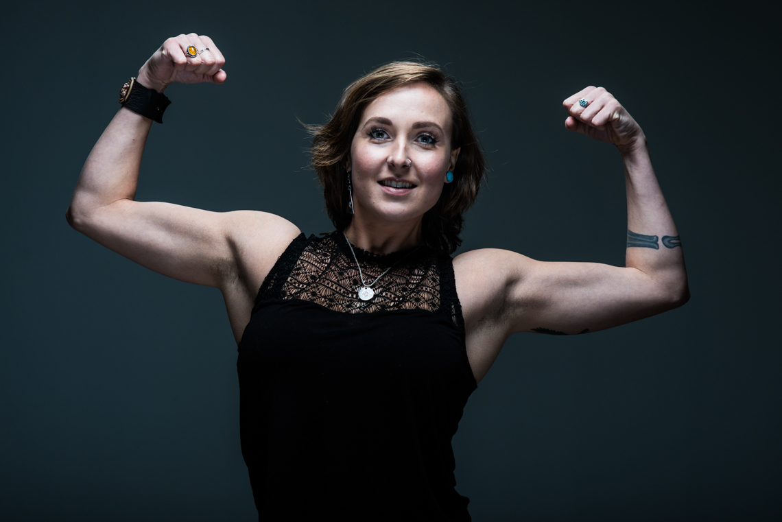 female fitness model flexes