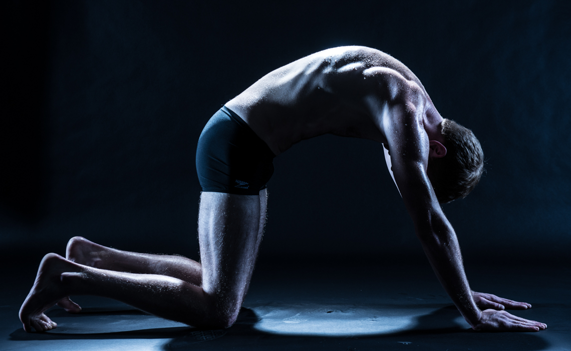 male model downward dog yoga