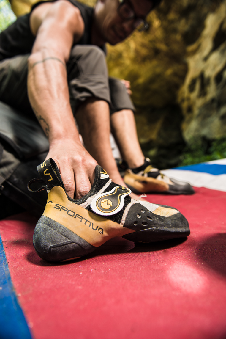 rock climber putting on his shoes, close up of the shoe