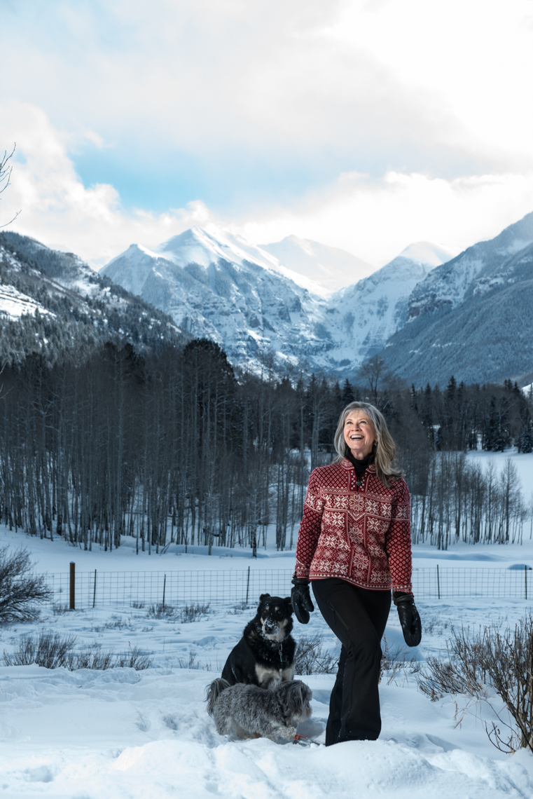 woman walks with her dog in Telluride Colorado