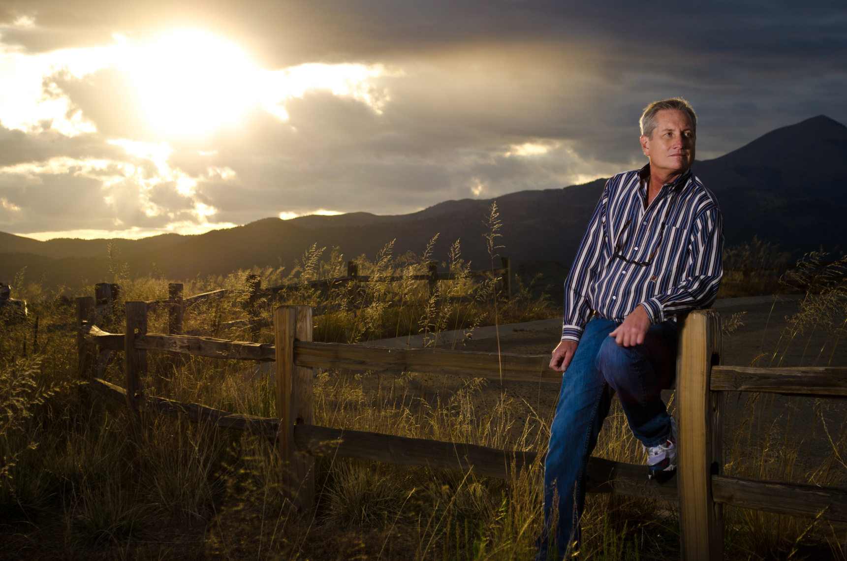 Portrait of cancer survivor in a field in New Mexico at sunset
