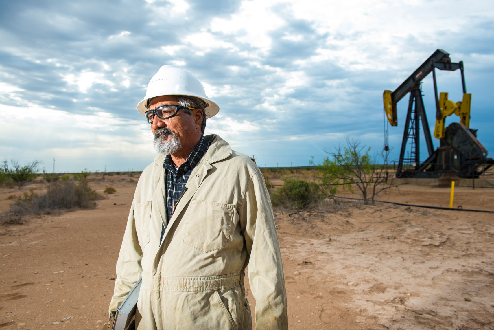oil rig worker by an oil rig in rural west Texas