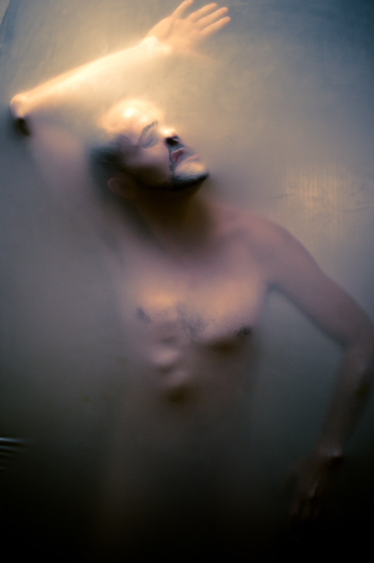 male model behind a translucent rubber wall